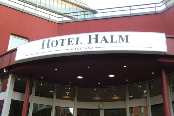 Lichtreklameschild leicht gebogen an Hotelaußenfassade